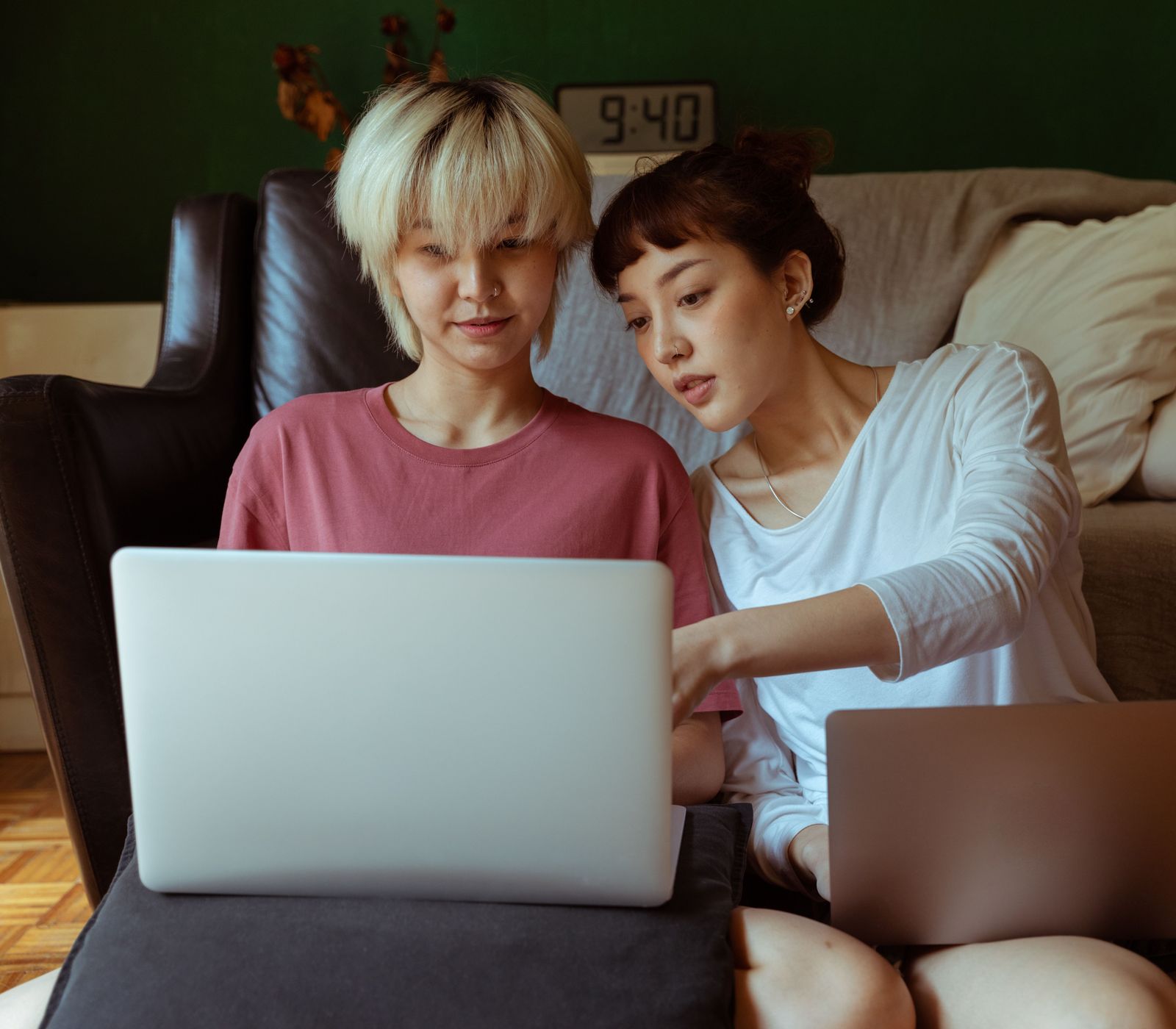 Two adult daughters at a laptop, looking through The Garden for their parent