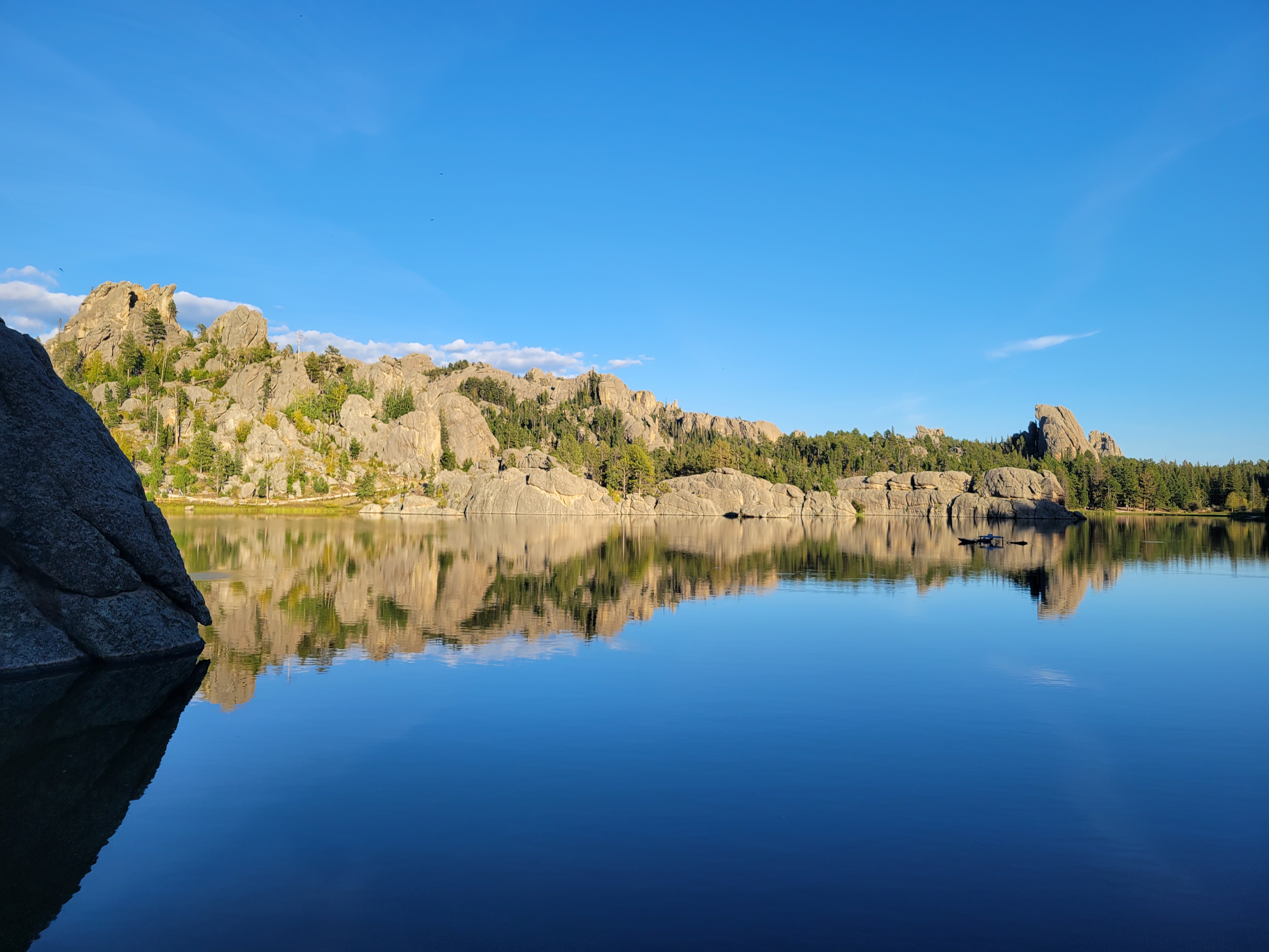 A still lake reflects the sky — the spirit of The Garden